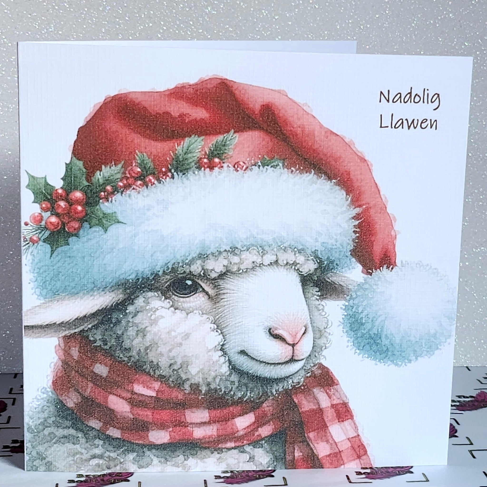 Nadolig Llawen Sheep Christmas Card Welsh Language Merry Christmas Sheep In Santa Hat With Holly And Scarf Linen Effect Free Delivery