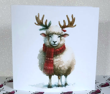 Christmas Reindeer Sheep Handmade Card With Scarf Woolly Sheep With Reindeer Antlers In Snow White Linen Effect Square Card Free Delivery