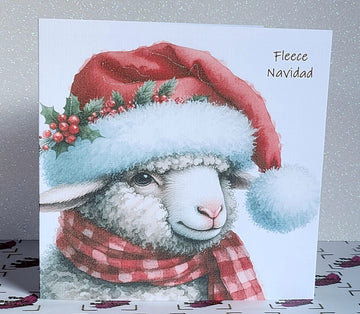 Feliz Navidad Sheep Christmas Card ' Fleece Navidad' Sheep In Santa Hat With Holly And Scarf Glitter Detailing Linen Effect Free Delivery