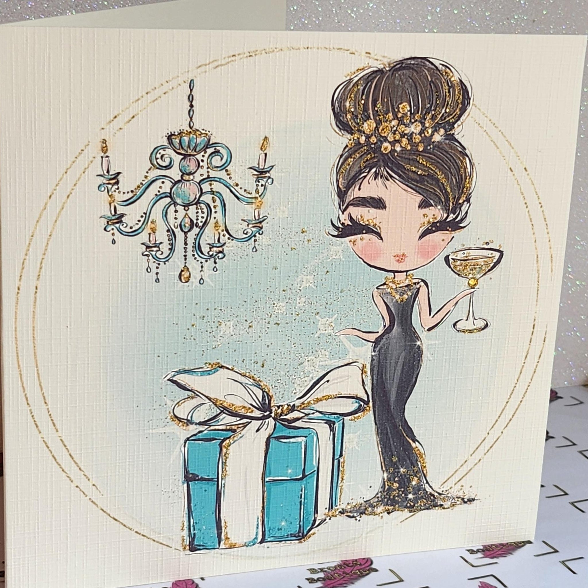 Birthday Card Brunette Girl Black Dress Champagne Glass Tiffany Gift Box Chandelier Messy Bun Swarovski Crystal Square Linen Free Delivery