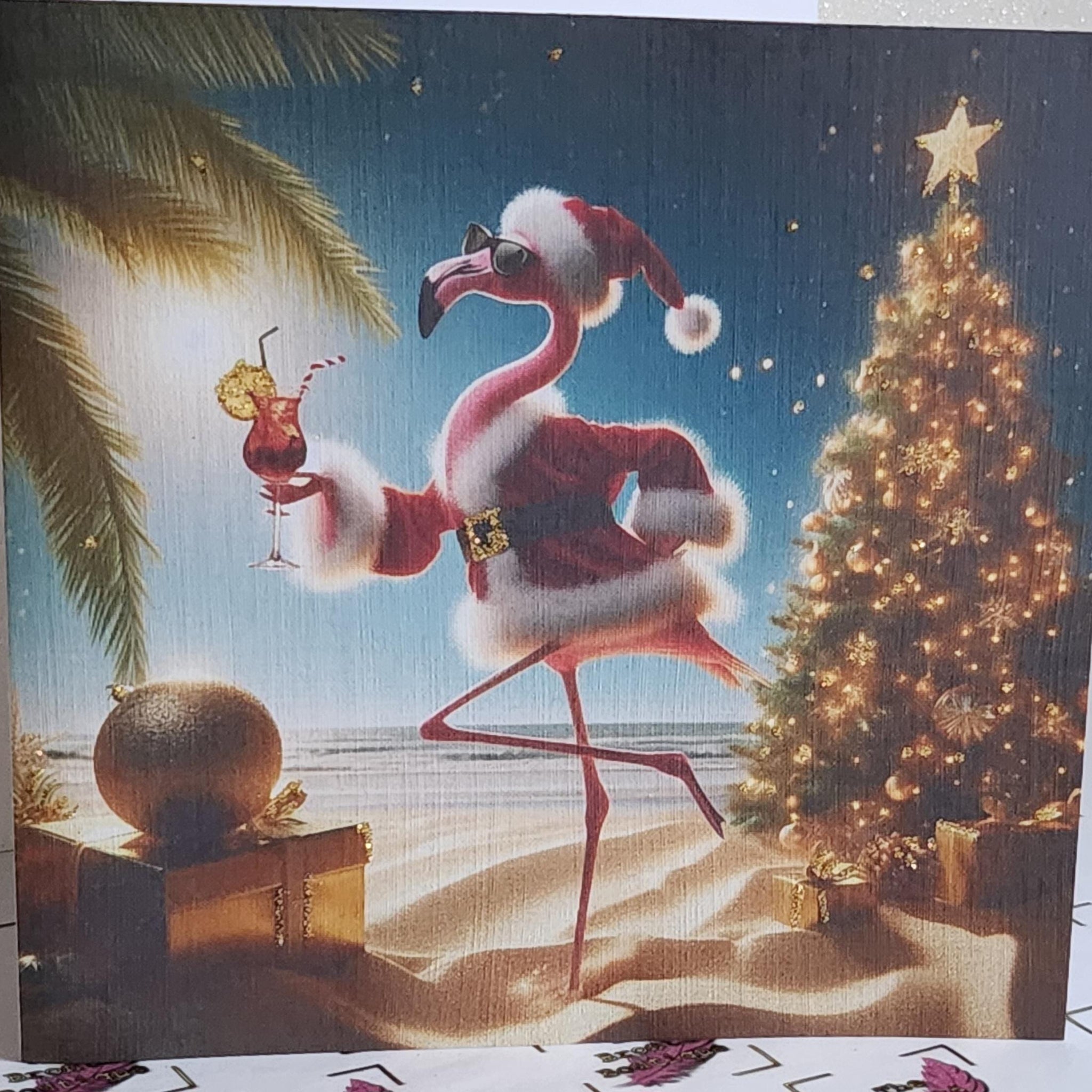 Flamingo Christmas Card 'Have A Flamazing Christmas' Flamingo Wearing Santa Outfit On Beach Gold Glitter Detail Linen Effect Free Delivery